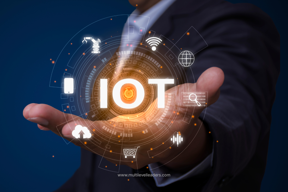 A business person holding a glowing IoT hologram with connected device icons