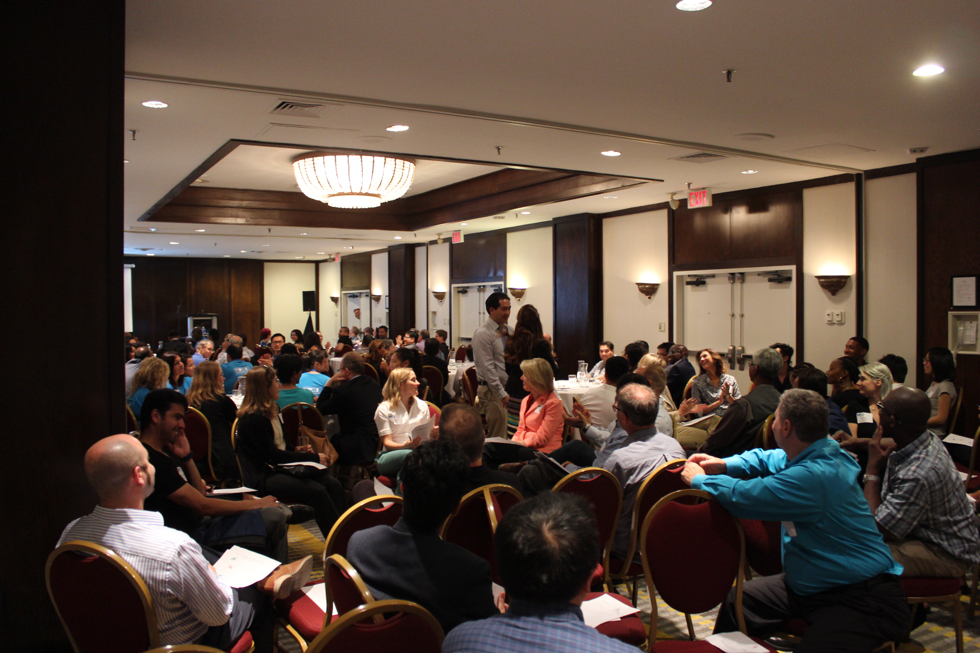 A leadership working session in progress with engaged participants at round tables